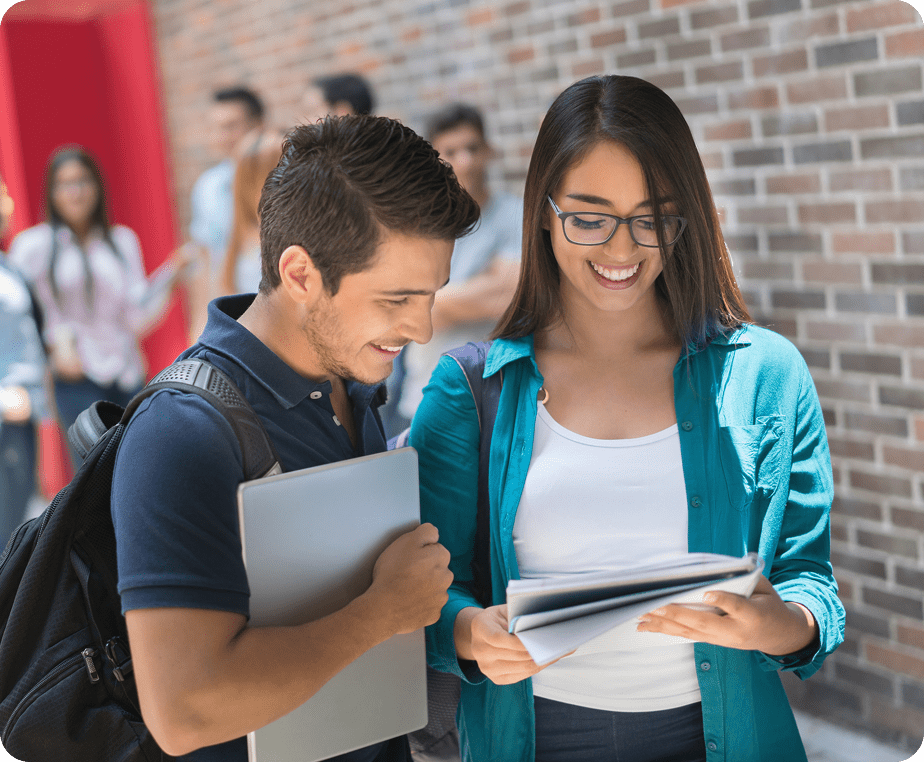 Students discussing notes outside school building